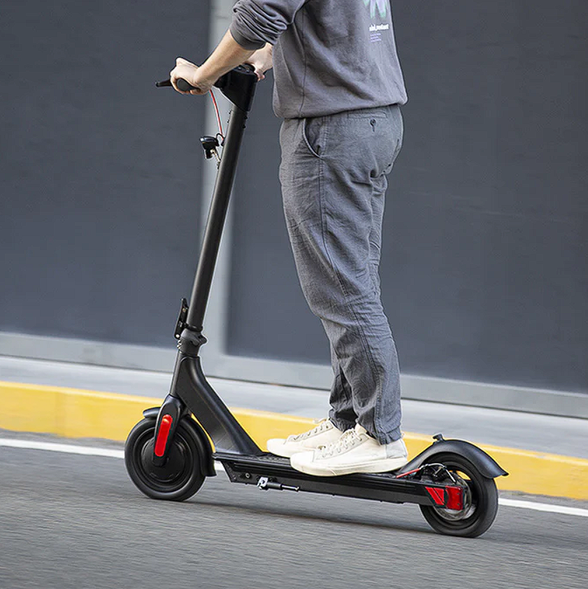 A man riding an e-scooter